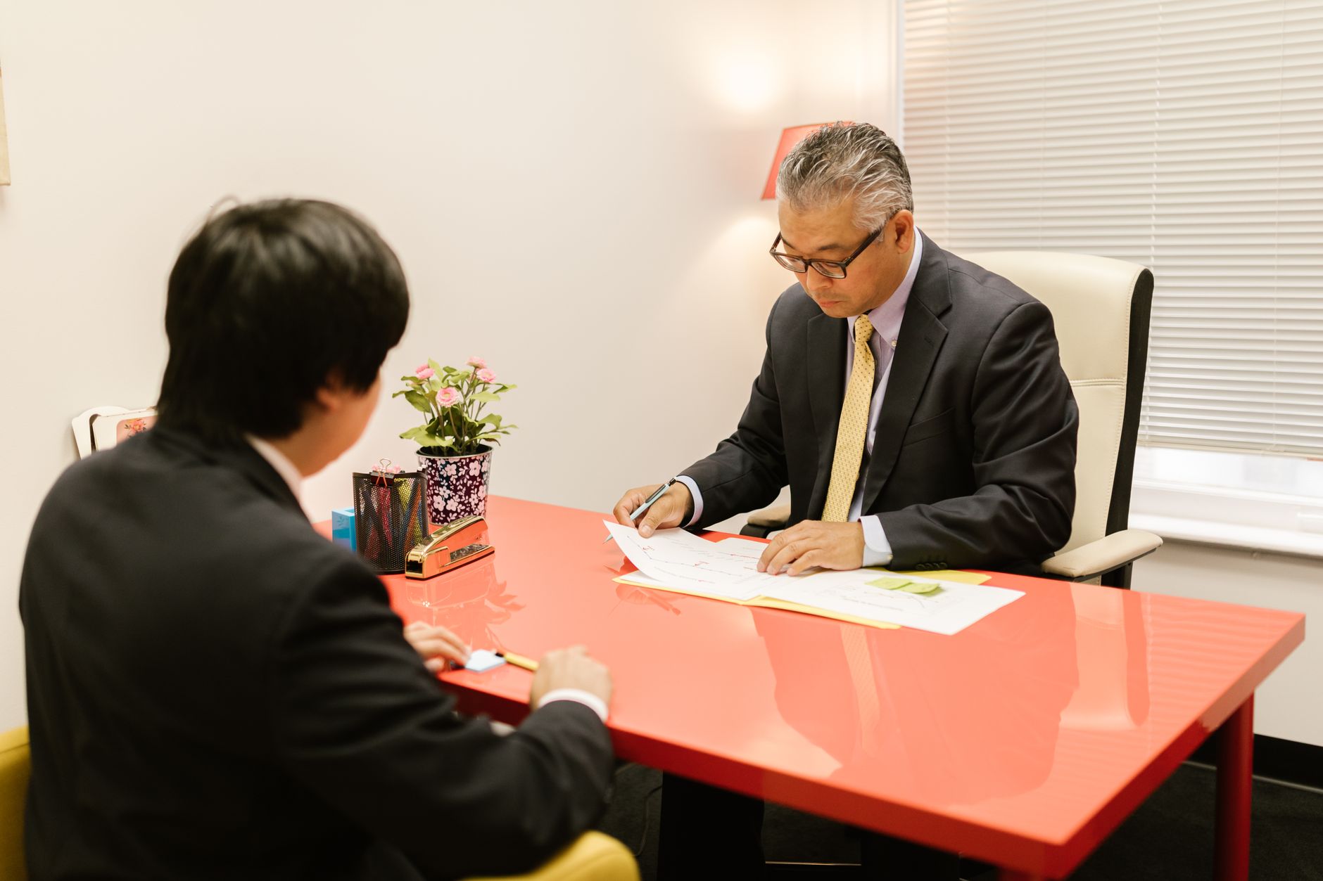 Two professionals reviewing documents at a desk
