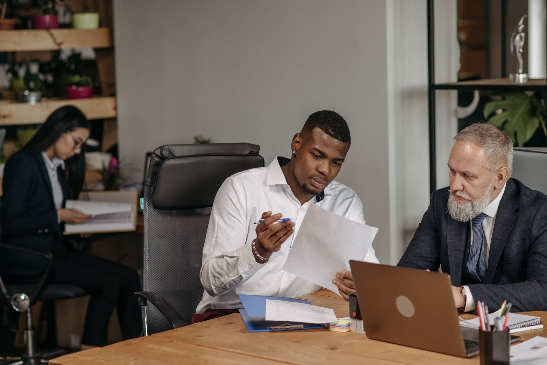 Professionals discussing documents in an office