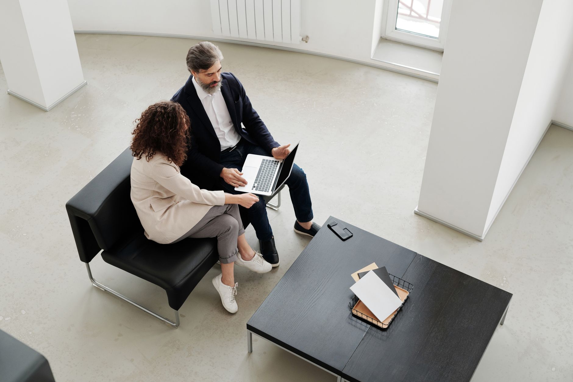 Two professionals collaborating in a bright office